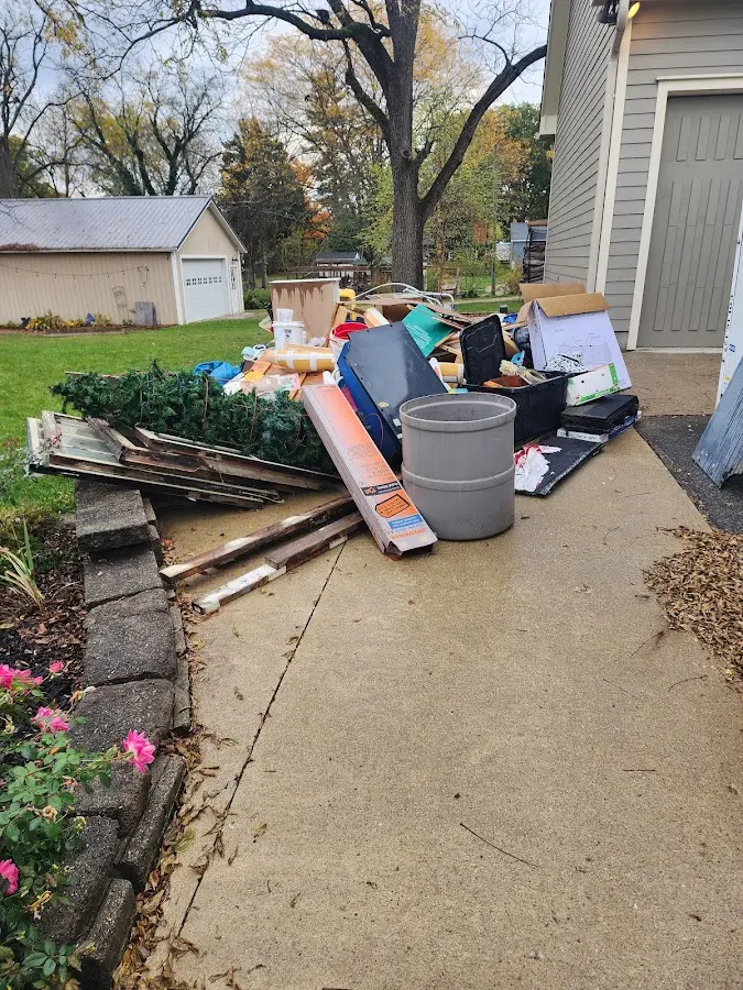 Dumpster being loaded with debris for 12 Yard Dumpster Rental in Fort Thomas